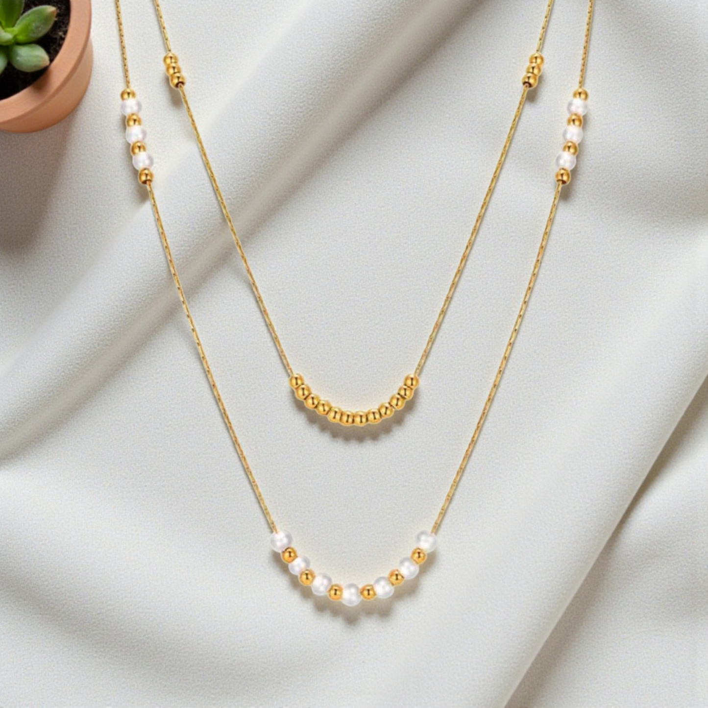 Colgante doble con perlas