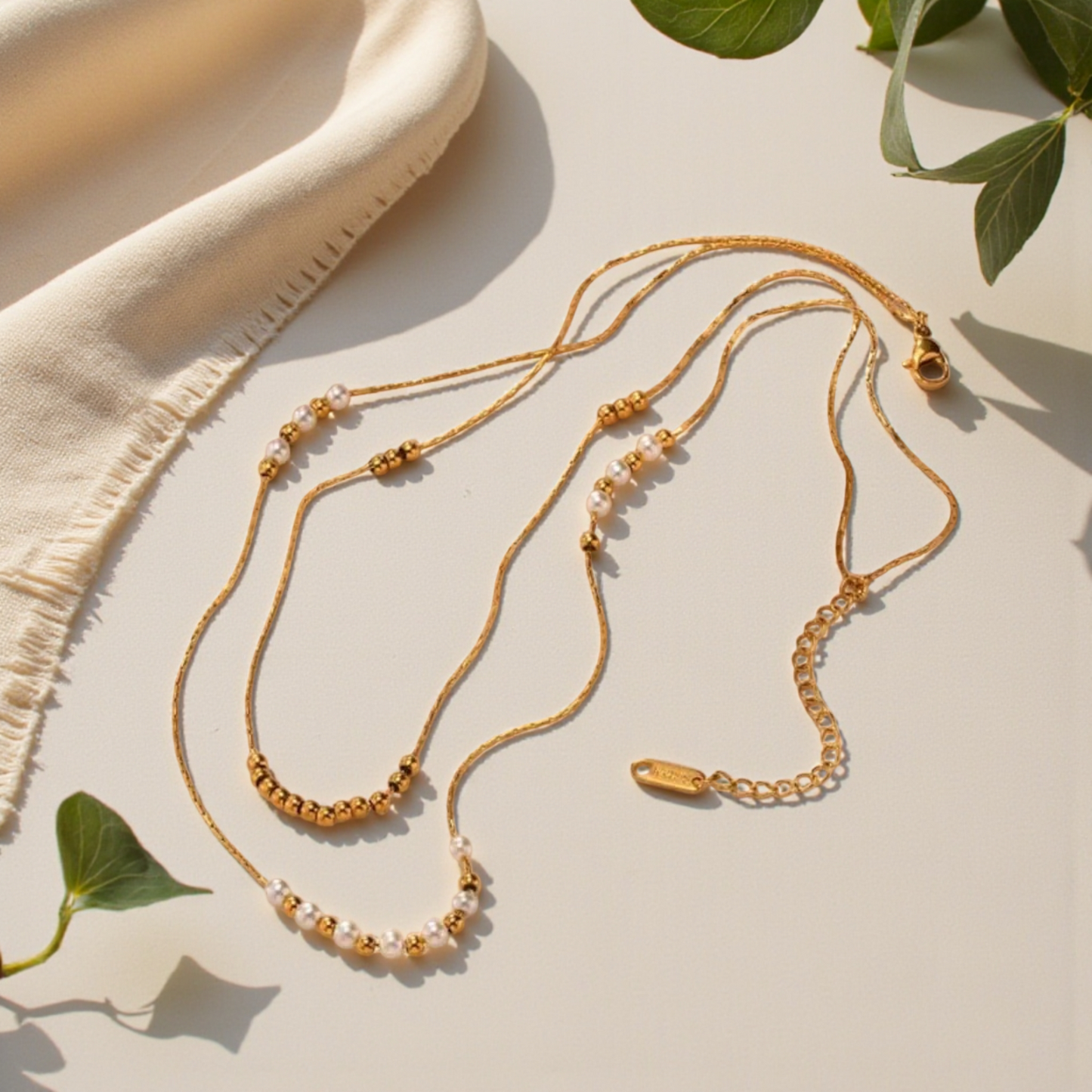 Colgante doble con perlas